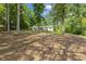 Charming home featuring a brick foundation, white siding, and mature shade trees surrounding the property at 418 S West St, Cary, NC 27511