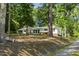 The home's exterior is surrounded by mature trees and a sloped lawn at 418 S West St, Cary, NC 27511