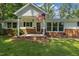 Inviting front porch with brick base and American flag waving in the breeze at 418 S West St, Cary, NC 27511