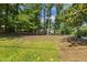 Landscaped front yard with established trees and a well-maintained lawn, creating a serene setting at 418 S West St, Cary, NC 27511