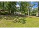 Spacious front yard featuring mature trees and lush green lawn leading up to the home at 418 S West St, Cary, NC 27511
