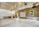 Unfinished garage has concrete flooring, wood framing, and an automatic garage door with windows at 418 S West St, Cary, NC 27511