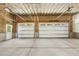 Unfinished garage with two car automatic doors provides plenty of space for parking and storage at 418 S West St, Cary, NC 27511