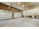 Unfinished garage with concrete floor features two automatic doors and an exit door at 418 S West St, Cary, NC 27511