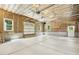 Bright and spacious garage with unfinished ceiling and walls features natural lighting and a side door at 418 S West St, Cary, NC 27511