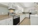 Well-lit kitchen featuring stainless steel appliances, light countertops and modern backsplash at 418 S West St, Cary, NC 27511