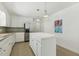 Kitchen featuring a central island with white countertops, stainless steel appliances, and tile flooring at 418 S West St, Cary, NC 27511