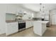 Charming kitchen with white cabinets, stainless steel appliances, kitchen island, and backsplash at 418 S West St, Cary, NC 27511