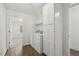 Well-lit laundry room with modern appliances, storage cabinets, and a side entry at 418 S West St, Cary, NC 27511