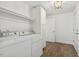 Bright laundry room with wooden floors, modern appliances and overhead lighting at 418 S West St, Cary, NC 27511