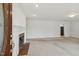Bright living room offers a white fireplace and mantle with neutral-colored carpet and fresh paint at 418 S West St, Cary, NC 27511