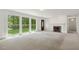 Bright living room featuring a fireplace, plush carpeting, and large windows offering scenic outdoor views at 418 S West St, Cary, NC 27511