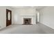 Inviting living room offers a fireplace, neutral-colored carpet, and a view of the doorway to another room at 418 S West St, Cary, NC 27511
