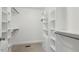 Spacious walk-in closet with built-in shelving and drawers, providing ample storage space at 418 S West St, Cary, NC 27511
