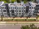Aerial view of townhouses showcasing architecture, green spaces, and a modern community layout at 421 Wait Ave # 100, Wake Forest, NC 27587