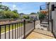 Balcony view of condos, street, and trees against a beautiful blue sky at 421 Wait Ave # 100, Wake Forest, NC 27587