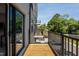 Cozy outdoor balcony with black metal railings and wooden deck, offering a private outdoor space at 421 Wait Ave # 100, Wake Forest, NC 27587
