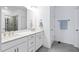 Bright bathroom featuring double vanity, white cabinets, quartz countertop, and glass shower at 421 Wait Ave # 100, Wake Forest, NC 27587