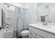 Bright bathroom with tiled shower, floral curtain, and a modern vanity at 421 Wait Ave # 100, Wake Forest, NC 27587