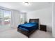 Bedroom with carpet flooring, a large window, and traditional wooden furniture at 421 Wait Ave # 100, Wake Forest, NC 27587