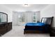 Bright bedroom featuring a large window, dresser, bedside tables, and carpet flooring at 421 Wait Ave # 100, Wake Forest, NC 27587