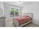 Cozy bedroom featuring neutral decor, carpeted floor, and window with natural light at 421 Wait Ave # 100, Wake Forest, NC 27587