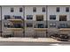 Modern townhouse exterior showing garages and balconies, offering contemporary living and convenient parking at 421 Wait Ave # 100, Wake Forest, NC 27587