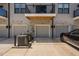 Exterior view of modern townhouses with garages, showcasing the facade and surrounding landscape at 421 Wait Ave # 100, Wake Forest, NC 27587