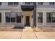 The townhome showcases its modern brick facade, covered entrance, and clear unit number at 421 Wait Ave # 100, Wake Forest, NC 27587