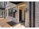 Modern townhome featuring a brick facade, covered entrance, and visible unit number at 421 Wait Ave # 100, Wake Forest, NC 27587