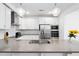 Bright kitchen with stainless appliances, gray countertops, white cabinetry, and pendant lighting at 421 Wait Ave # 100, Wake Forest, NC 27587
