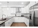 Modern kitchen featuring white cabinetry, stainless steel appliances, and a spacious countertop area at 421 Wait Ave # 100, Wake Forest, NC 27587