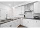 Bright kitchen featuring modern white cabinets, stainless steel appliances, and sleek countertops at 421 Wait Ave # 100, Wake Forest, NC 27587