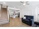 Open-concept living room with hardwood floors that flows into a kitchen and staircase at 421 Wait Ave # 100, Wake Forest, NC 27587