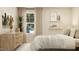 Bright bedroom featuring a bed with pillows, nightstands, lamps, window, and dresser at 43 Regal Gardens Ct, Angier, NC 27501