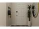 Welcoming entryway featuring a white door, plant, a mirror, and a convenient coat rack for hanging items at 43 Regal Gardens Ct, Angier, NC 27501