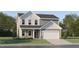 Charming two-story home featuring a two-car garage and a combination of stone and siding accents at 43 Regal Gardens Ct, Angier, NC 27501