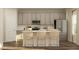 Modern kitchen featuring stainless steel appliances, ample cabinets, and a convenient breakfast bar at 43 Regal Gardens Ct, Angier, NC 27501