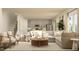 Open-concept living area with a cozy couch, chairs, and seamless access to a well-equipped kitchen at 43 Regal Gardens Ct, Angier, NC 27501