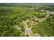 A scenic aerial view showcases the property nestled amongst lush trees, offering both privacy and natural beauty at 4605 Malor Dr, Wake Forest, NC 27587