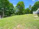 Expansive backyard featuring a lush lawn and mature trees at 4605 Malor Dr, Wake Forest, NC 27587