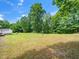 Expansive backyard featuring large trees and open grassy areas at 4605 Malor Dr, Wake Forest, NC 27587
