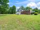 Large backyard featuring mature trees and a deck at 4605 Malor Dr, Wake Forest, NC 27587