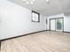 Finished basement featuring wood-look tile flooring, a window, and sliding glass doors to the exterior at 4605 Malor Dr, Wake Forest, NC 27587