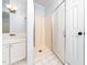 Bathroom featuring tiled shower, white vanity, and bright lighting at 4605 Malor Dr, Wake Forest, NC 27587