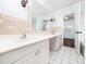 Spacious bathroom with double vanity, large mirror, and tiled walls at 4605 Malor Dr, Wake Forest, NC 27587