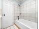 Clean white bathroom featuring a tub with tiled walls at 4605 Malor Dr, Wake Forest, NC 27587