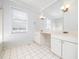 Bright bathroom with white cabinets, double vanity, and tiled floors at 4605 Malor Dr, Wake Forest, NC 27587