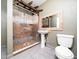 Bathroom with tiled shower, pedestal sink, and a toilet at 4605 Malor Dr, Wake Forest, NC 27587