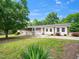 Beautiful exterior view of a house featuring brick and white siding, a green lawn, and mature landscaping at 4605 Malor Dr, Wake Forest, NC 27587